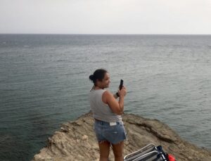 Mujer fotografiando el mar.